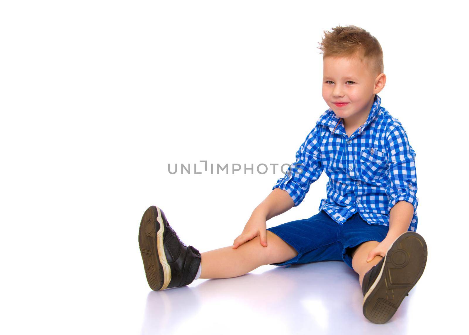 little boy is sitting on the floor by kolesnikov_studio