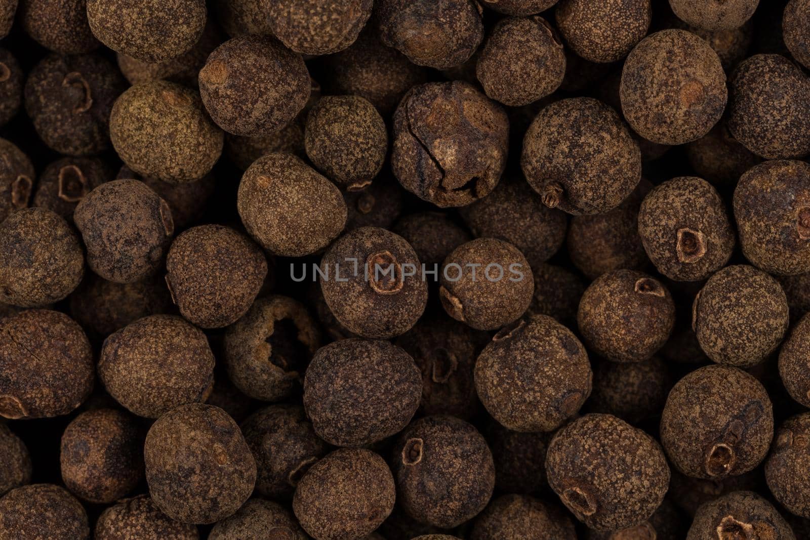 Large black pepper seeds corns as a background