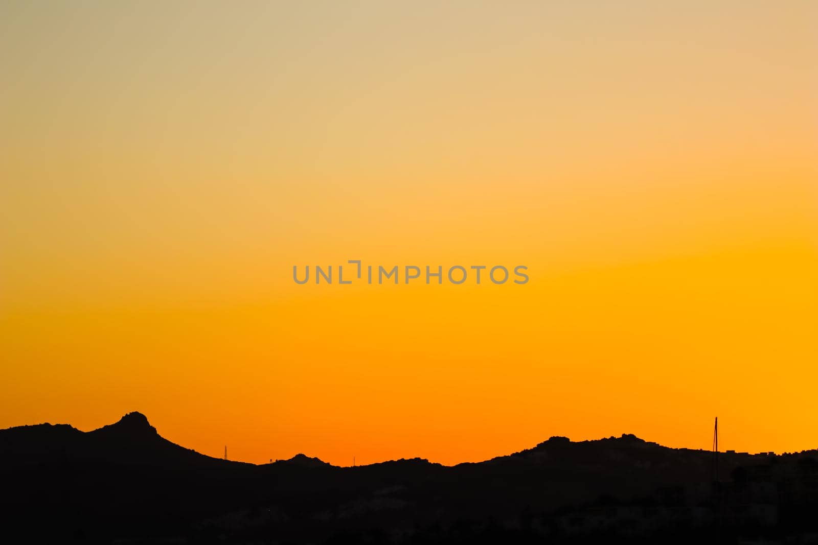 Background from a beautiful colorful sunset with the silhouette of the mountains. High quality photo