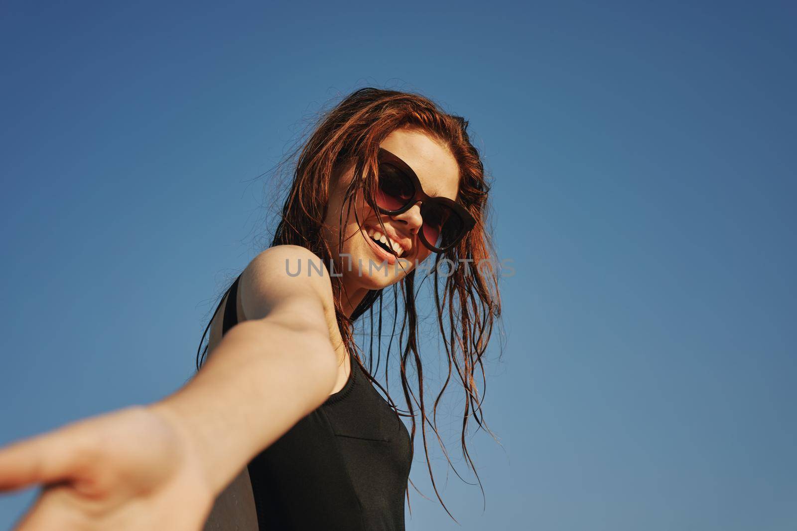 woman in black swimsuit sunglasses sun nature. High quality photo