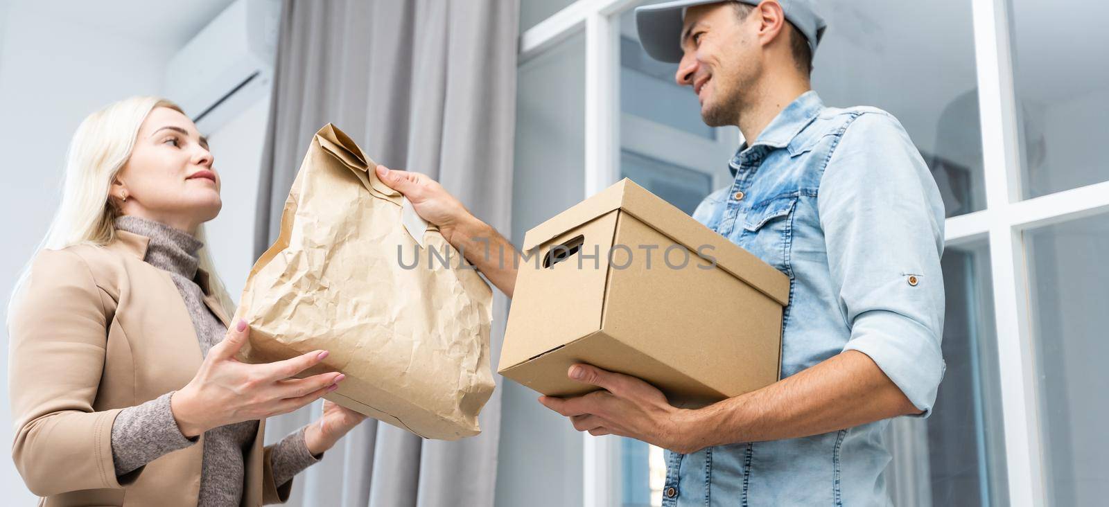 woman receiving package from delivery man.