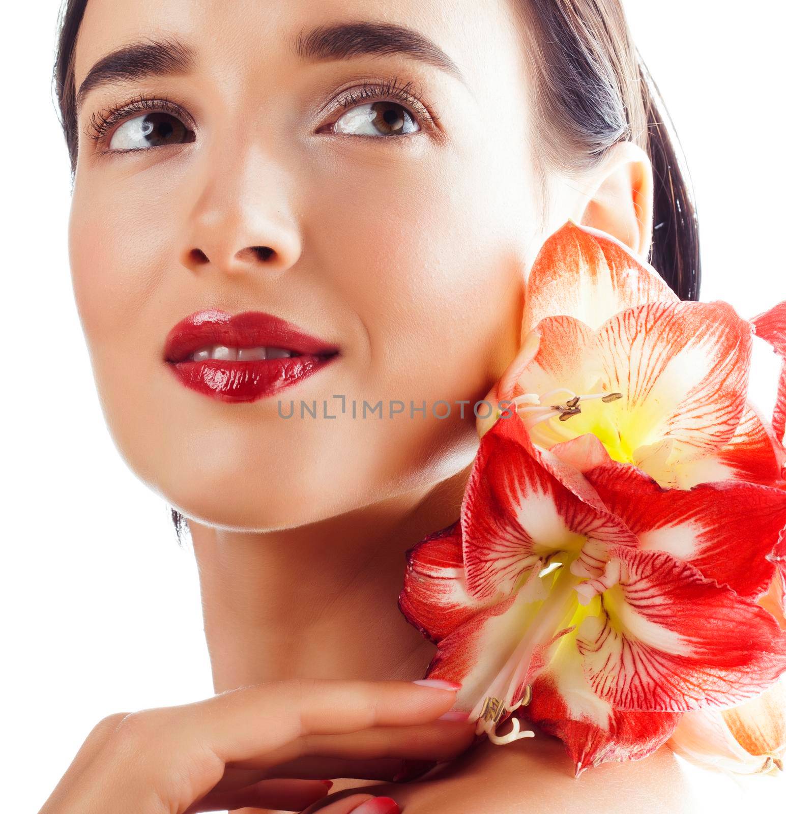 young pretty brunette real woman with red flower amaryllis isolated on white background