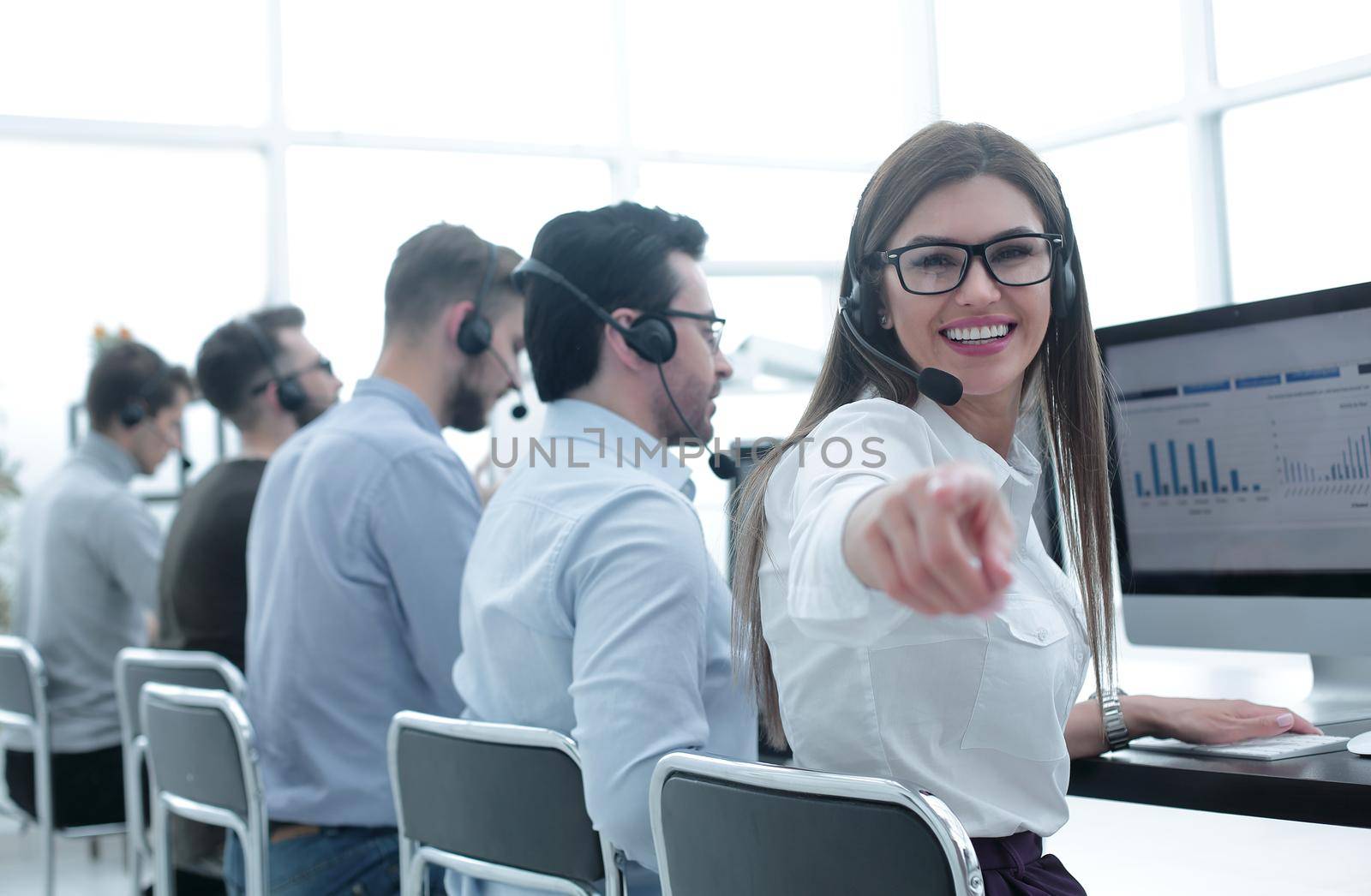 smiling business center employee pointing a finger at you by asdf