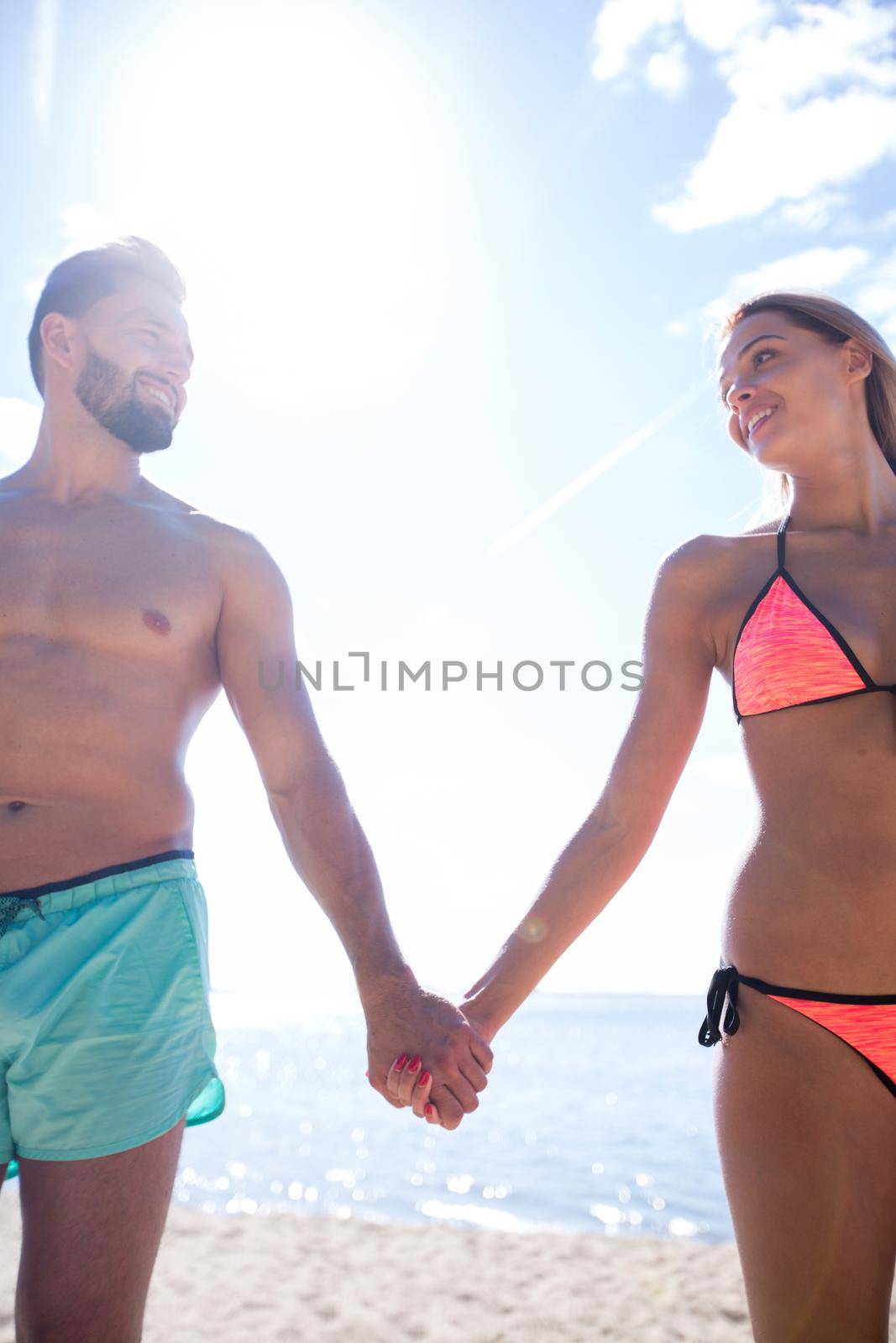 Honeymoon couple holding hand walking on beautiful white sand be by asdf