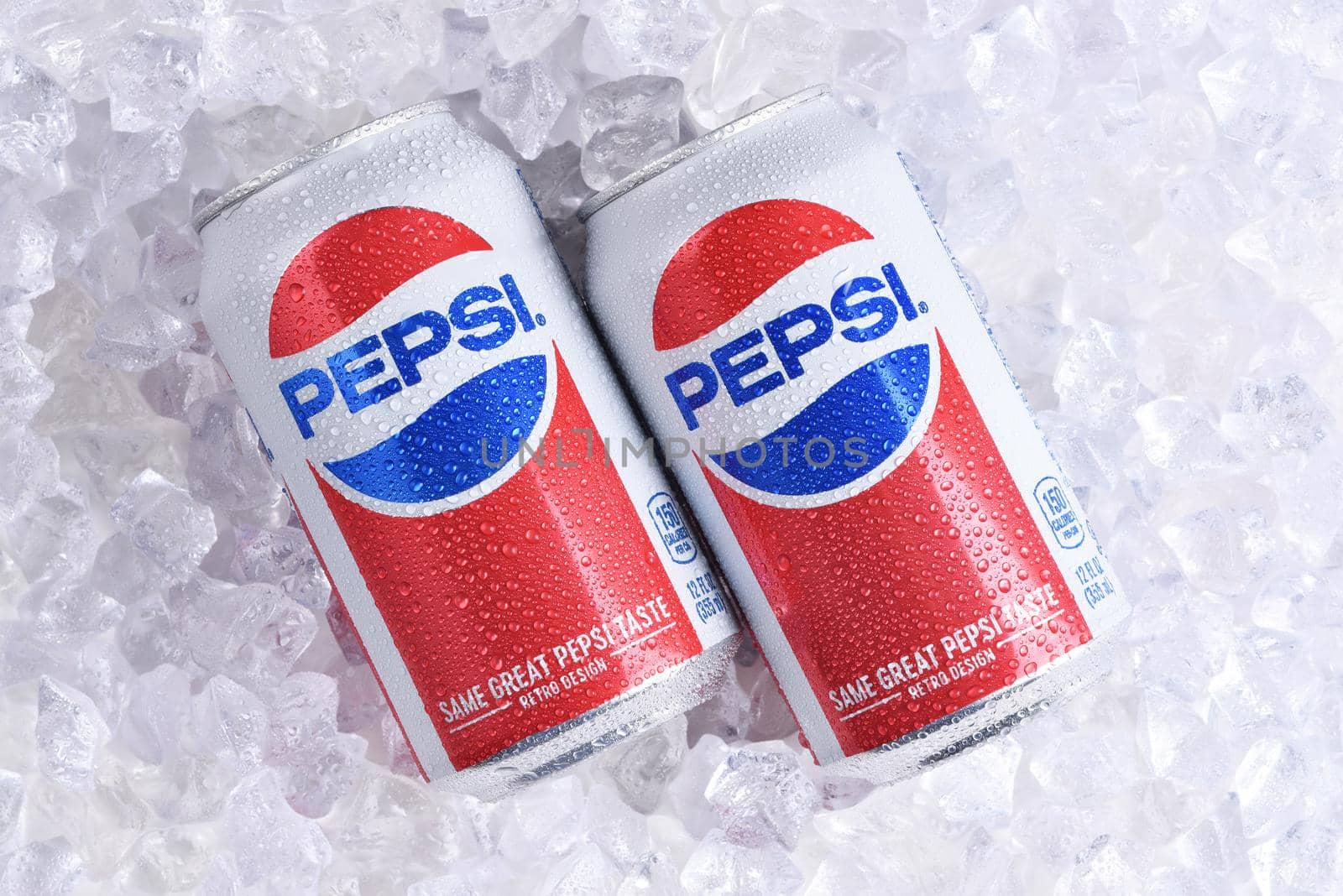 IRVINE, CALIFORNIA - MAY 23, 2018: Two cans of Pepsi-Cola on ice. Pepsi is one of the leading producers of soda and soft drinks in the USA.