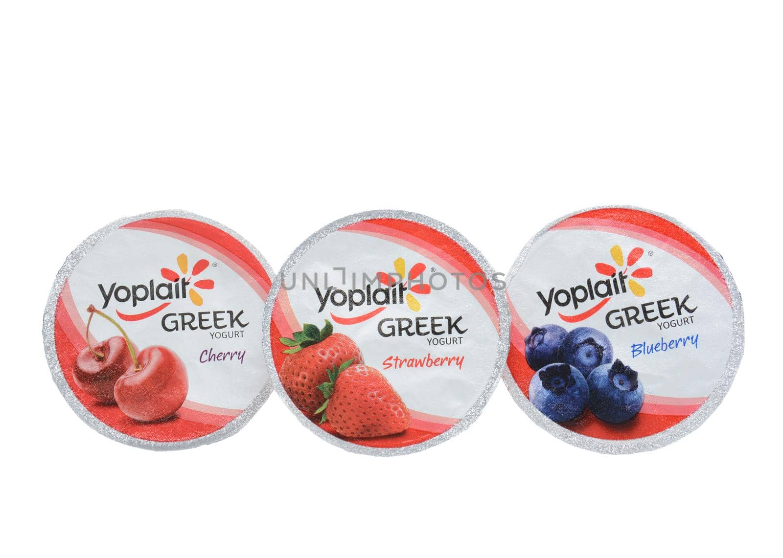 IRVINE, CA - SEPTEMBER 15, 2014: Three different containers of Yoplait Greek Yogurt isolated on white. In 1965, two French dairy co-operatives, Yola and Coplait, merged, becoming Yoplait.