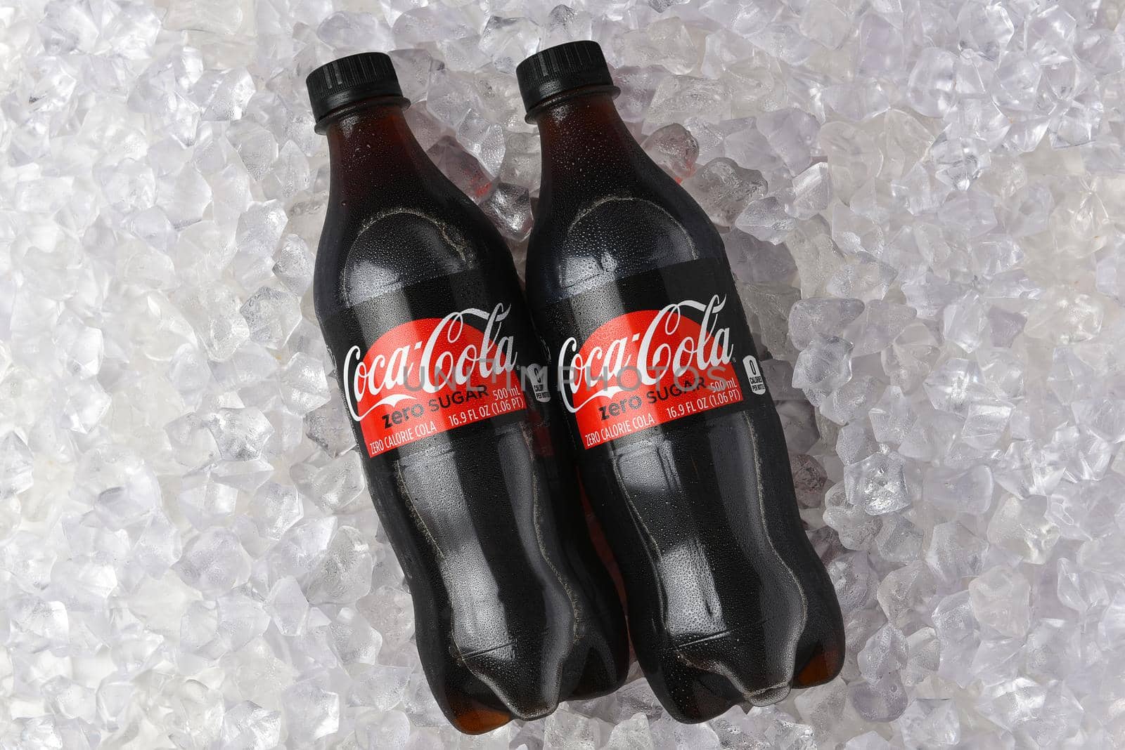 IRVINE, CALIFORNIA - 26 JUNE 2021: Two plastic bottles of Coca-Cola Zero in a bed of ice.