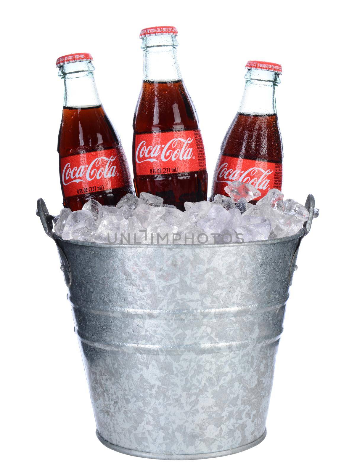 IRVINE, CA - February 06, 2014: Threes bottles of Coca-Cola in and Ice bucket. Coke is one of the most popular soft drinks in the world.