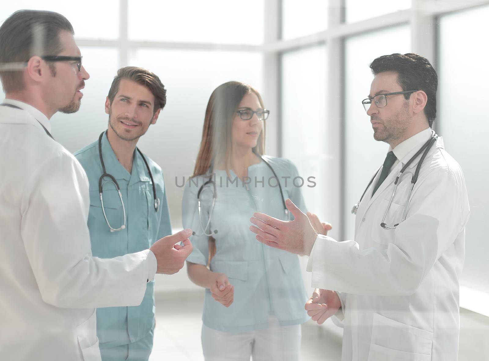 group of doctors discussing problems in the hospital corridor .the concept of communication