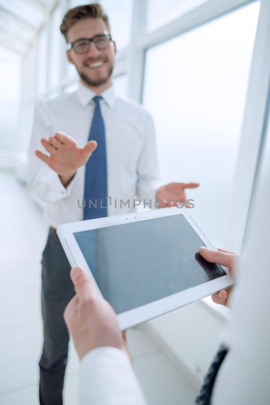 close up.businessman with digital tablet on office background by asdf