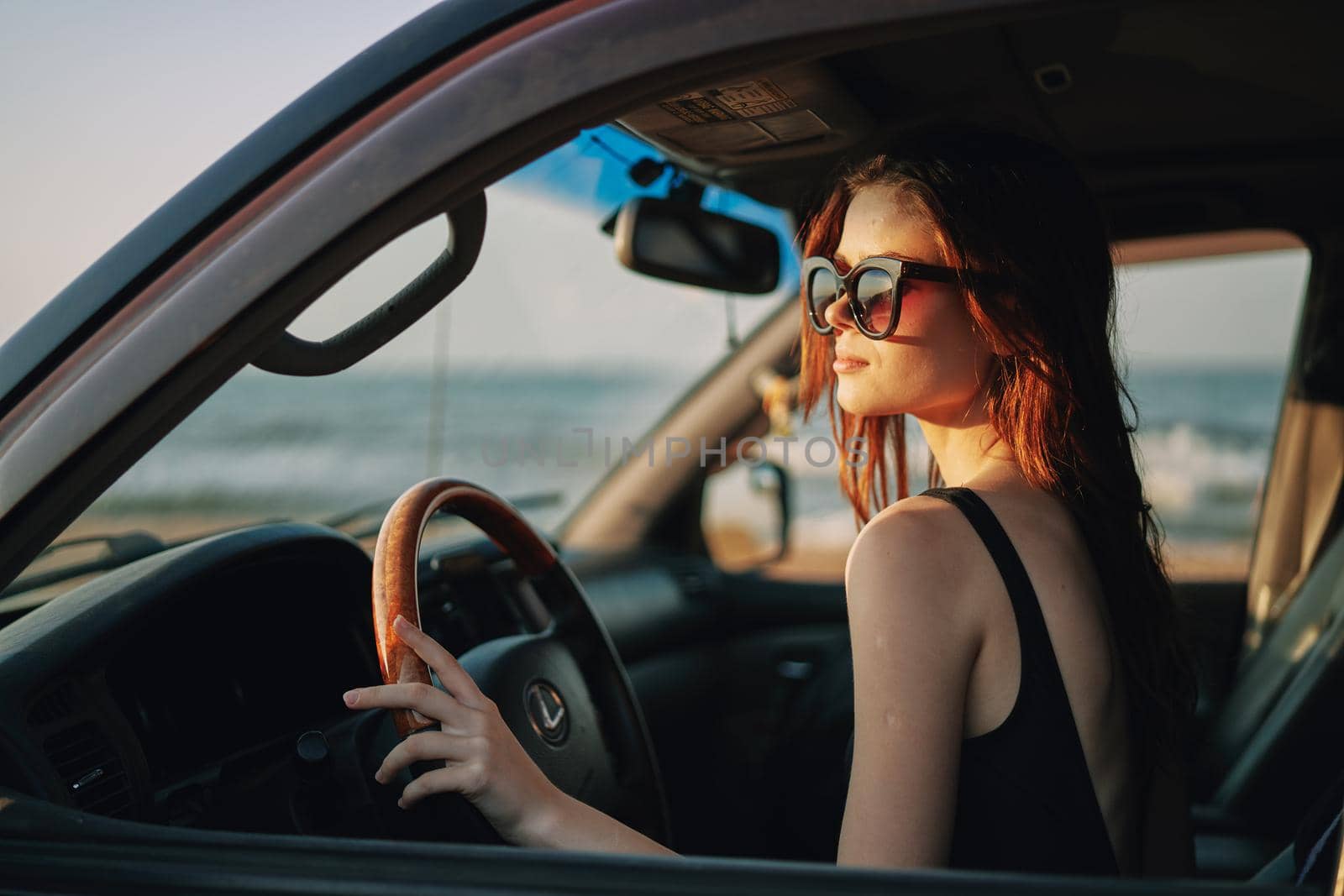 pretty woman in sunglasses driving a car trip. High quality photo
