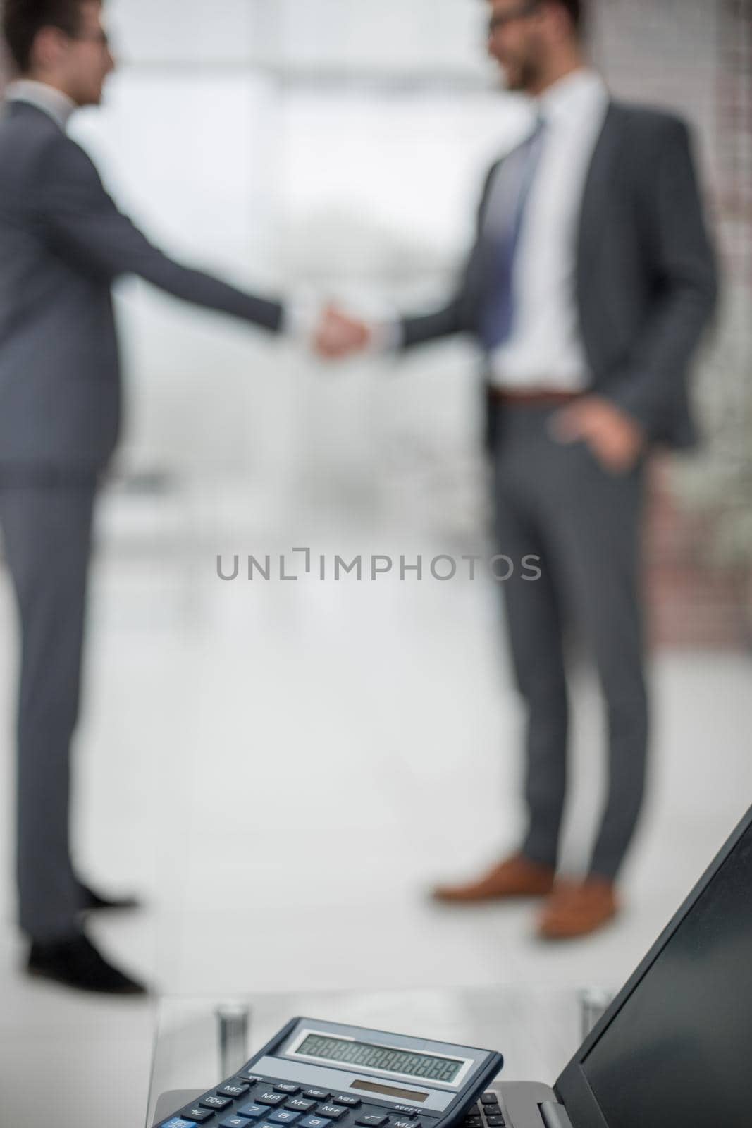 blurred image of a handshake of business people in the office.business background