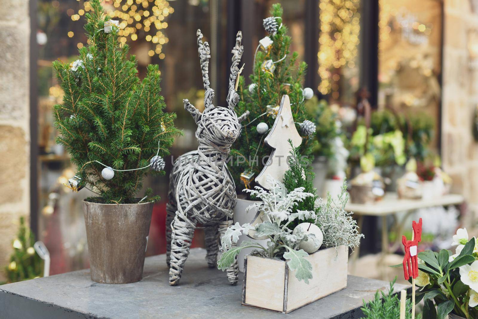 Decorated Christmas tree in a white pot in a shop