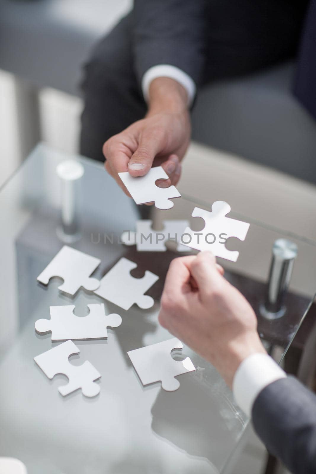 business partners put the pieces of the puzzle.the concept of cooperation