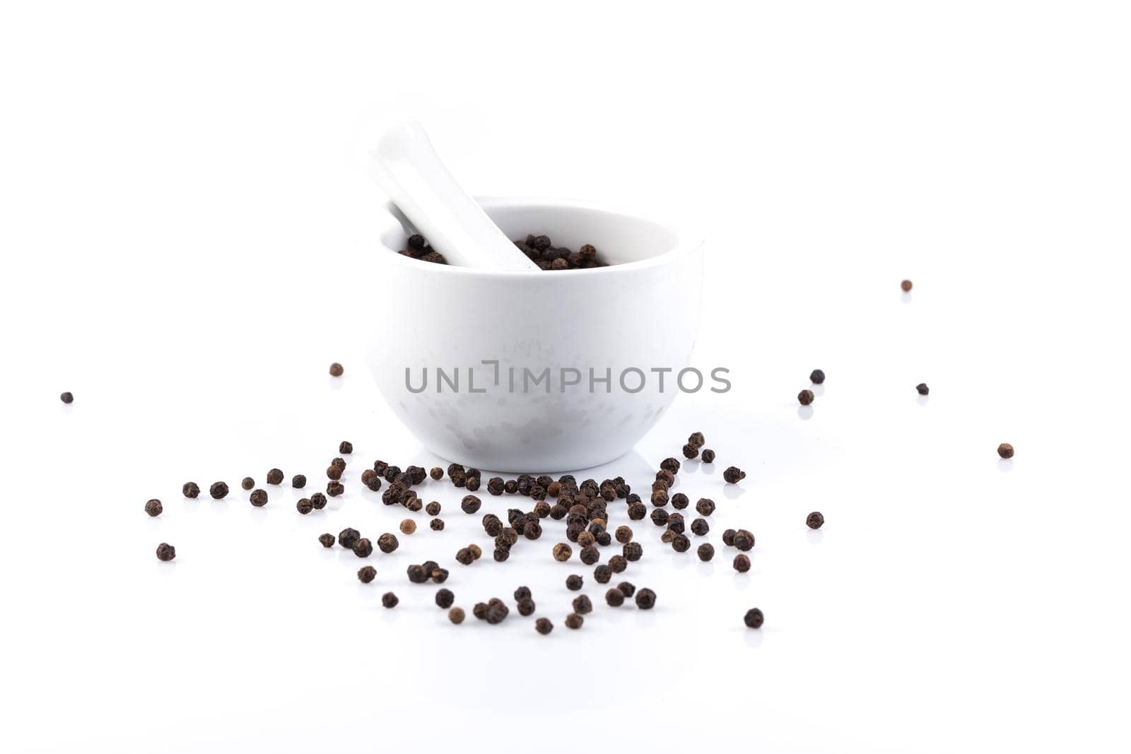Peppercorns in mortar and pestle by RTsubin