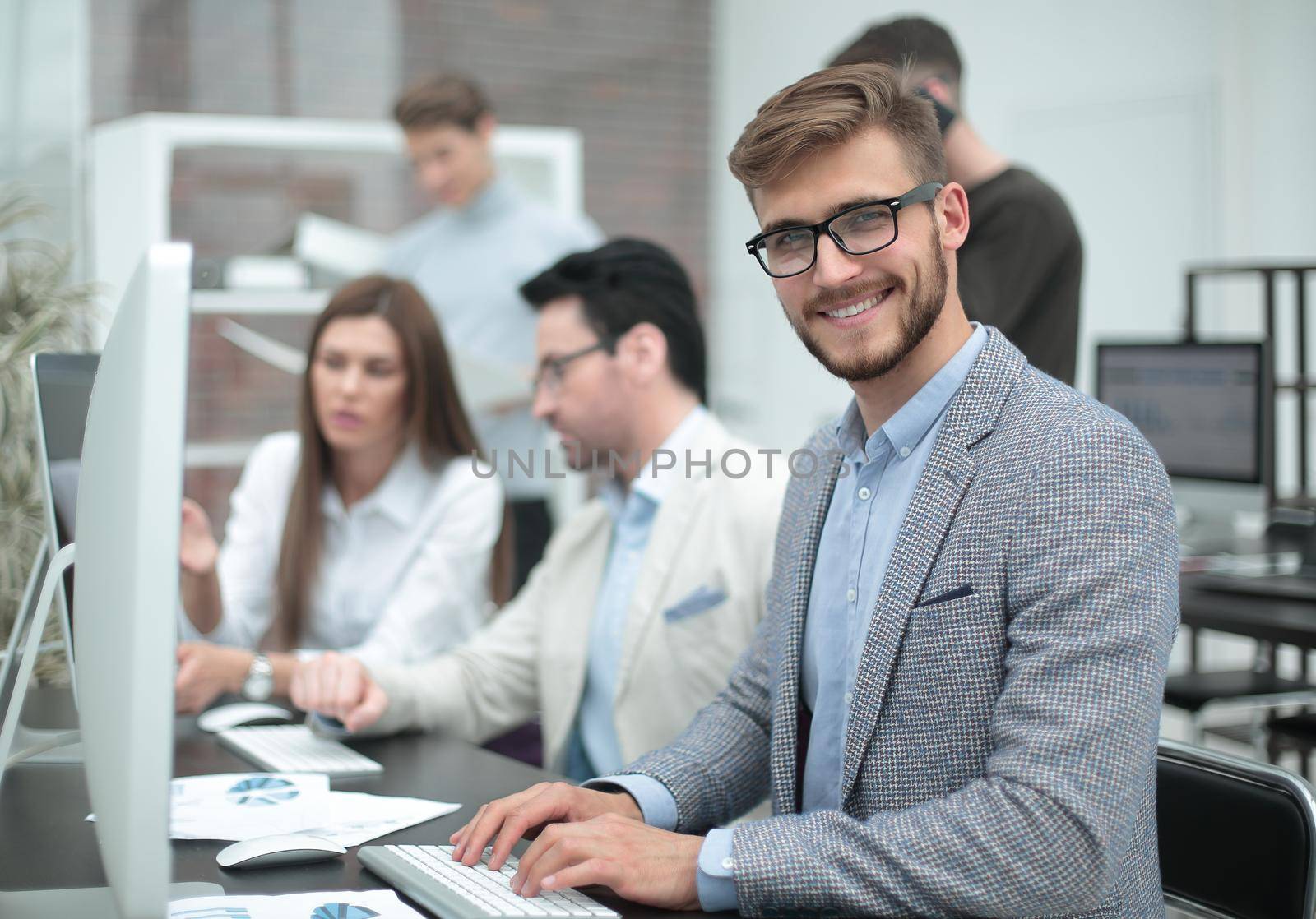 businessman sitting at his Desk by asdf