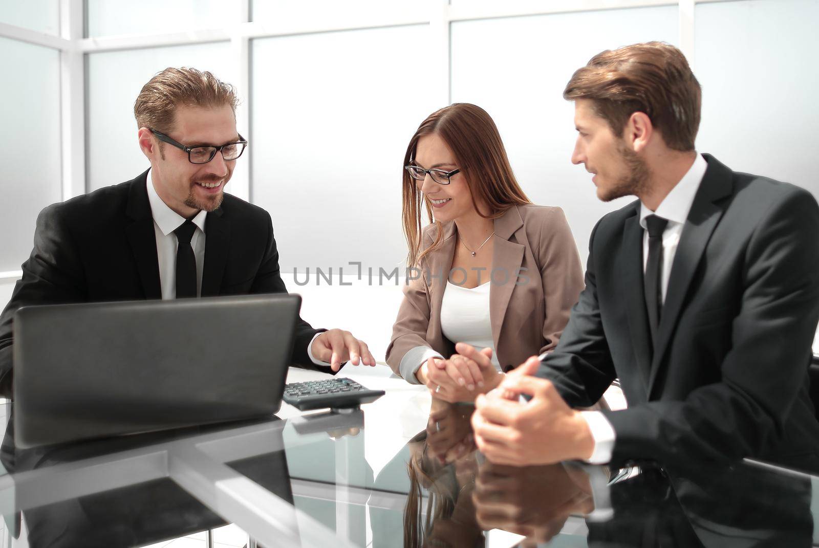 Businesswoman presenting to colleagues at a meeting by asdf