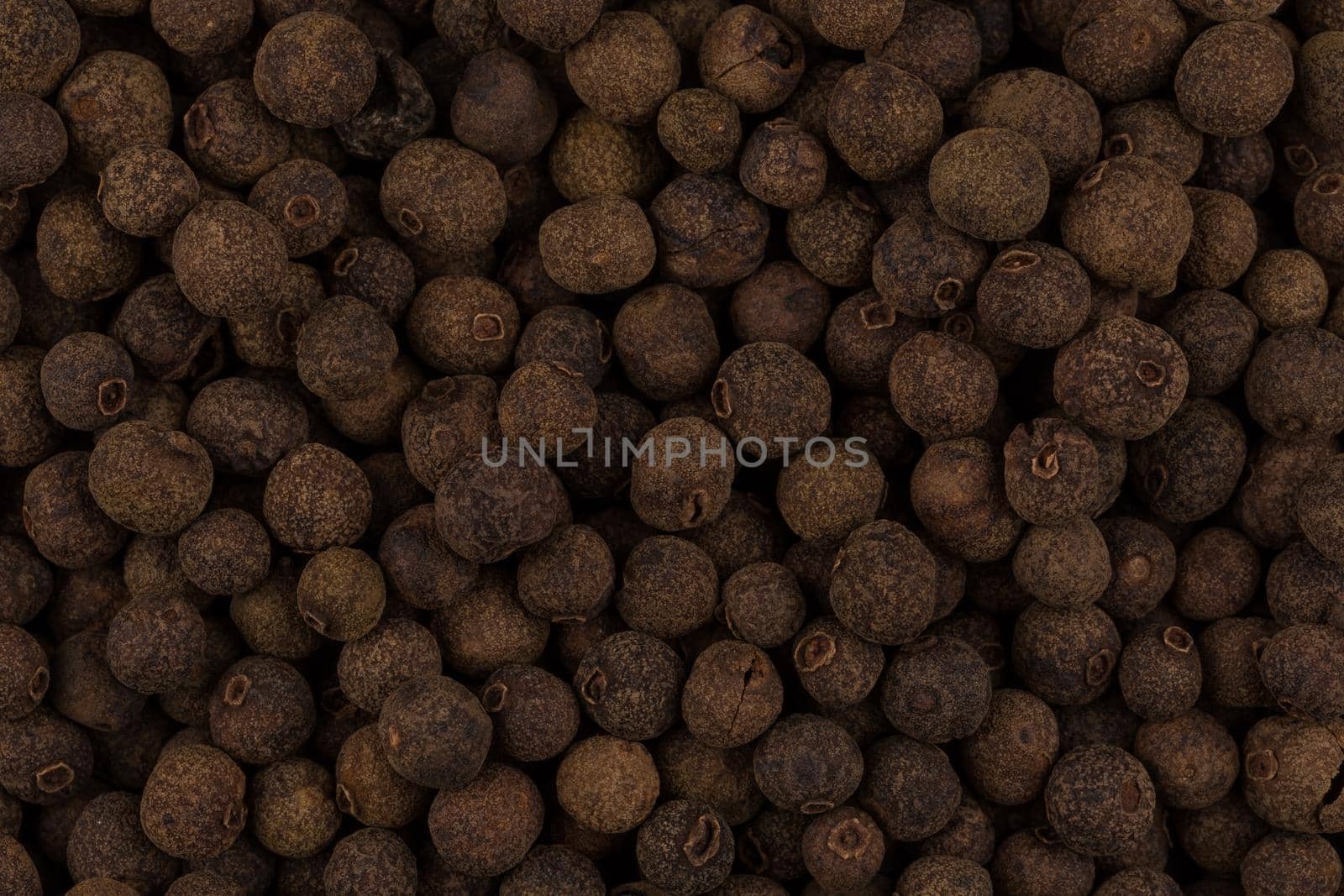 Large black pepper seeds corns as a background