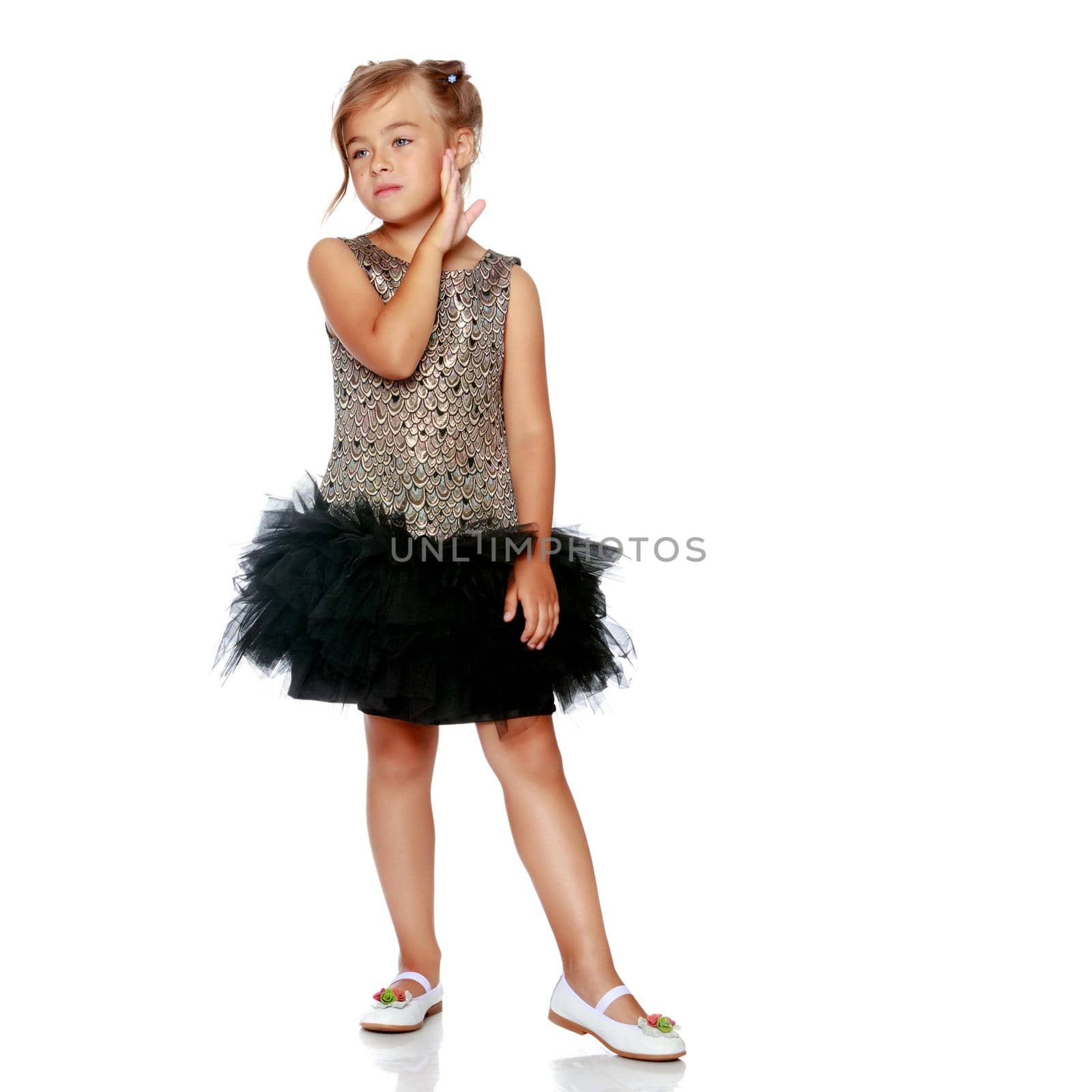 Studio portrait of a beautiful little girl. The concept of fashion, family happiness, harmonious development of the child. Isolated on white background.