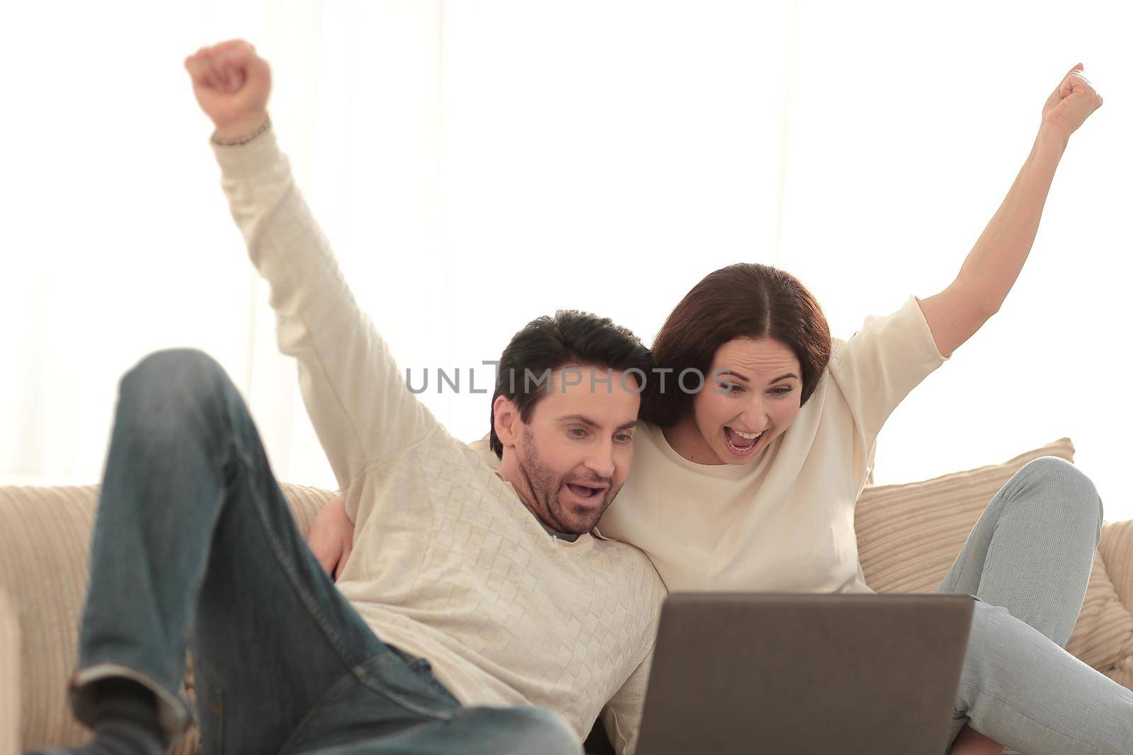 young couple is rooting for their favorite team .people and technology