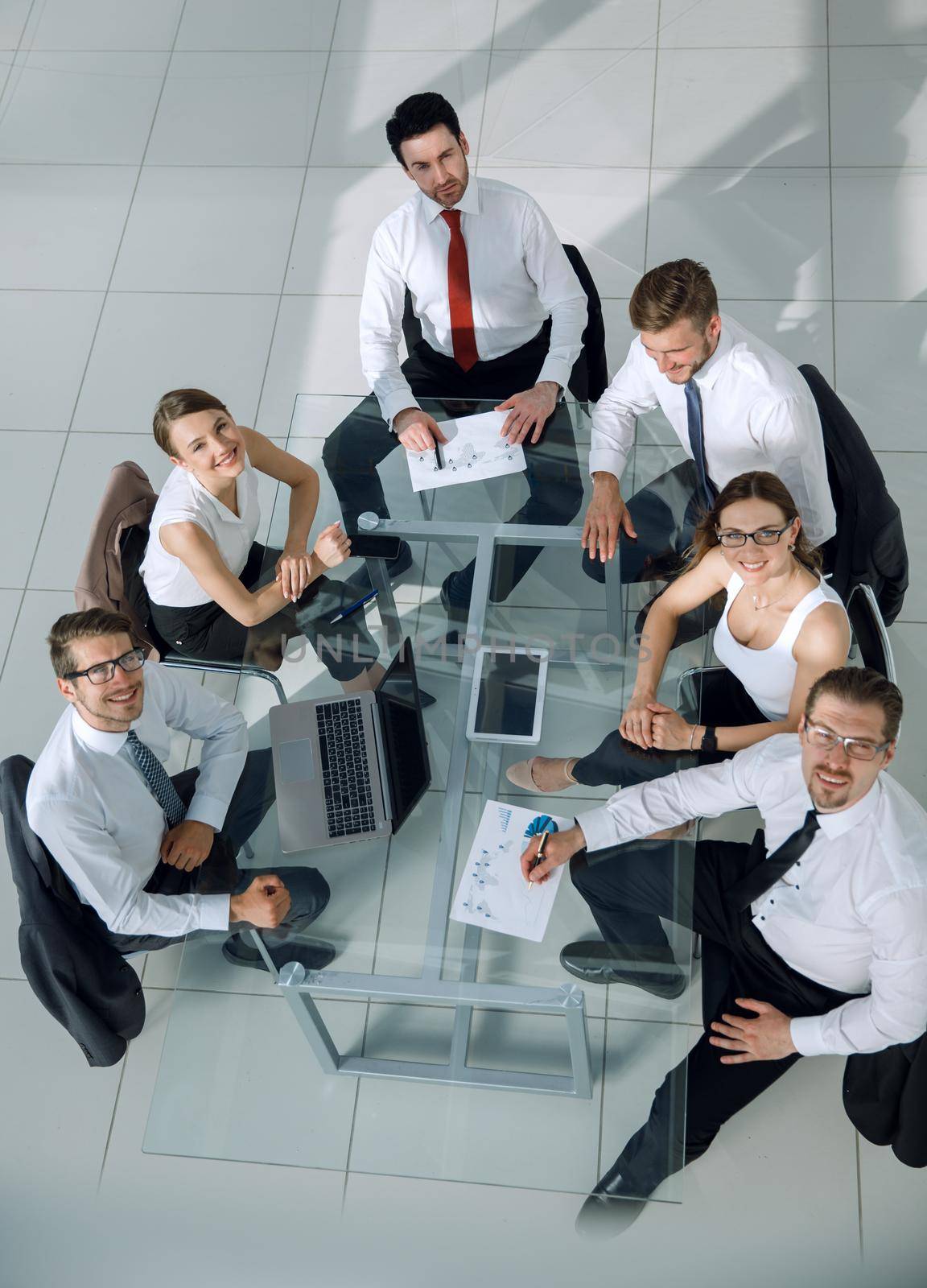 Business People Working Around a Conference Table by asdf