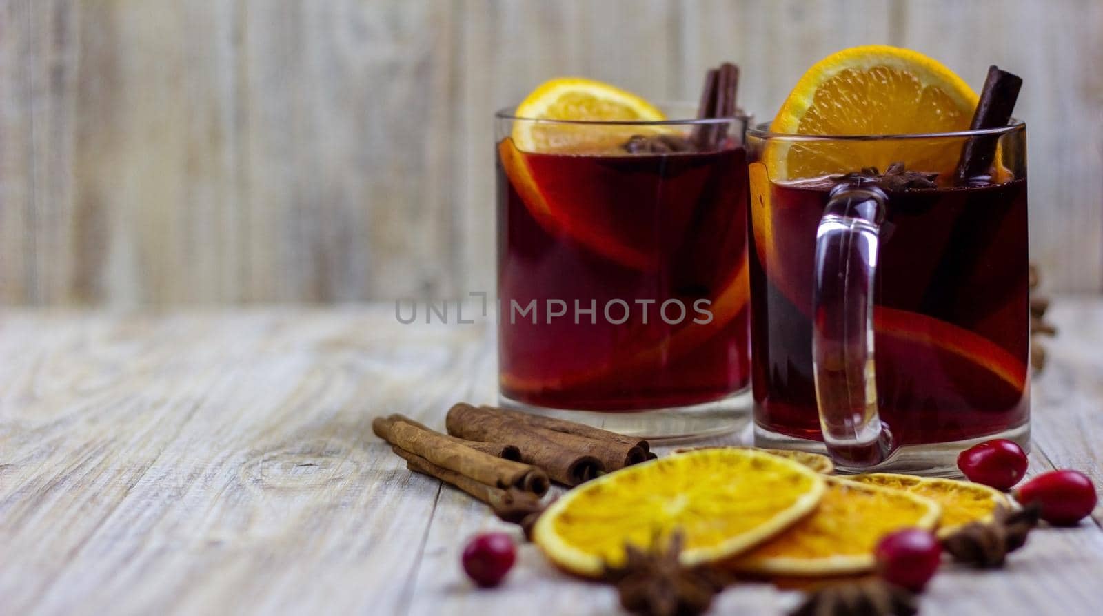 glasses with mulled wine on wooden background. new year concept. Selective focus