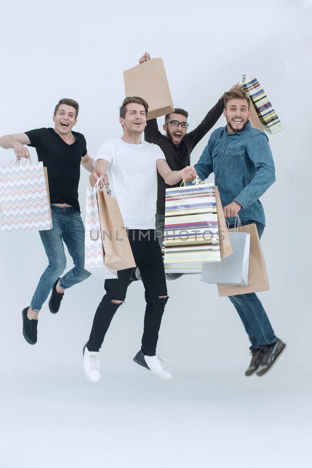 group of dancing friends with shopping. the concept of happiness