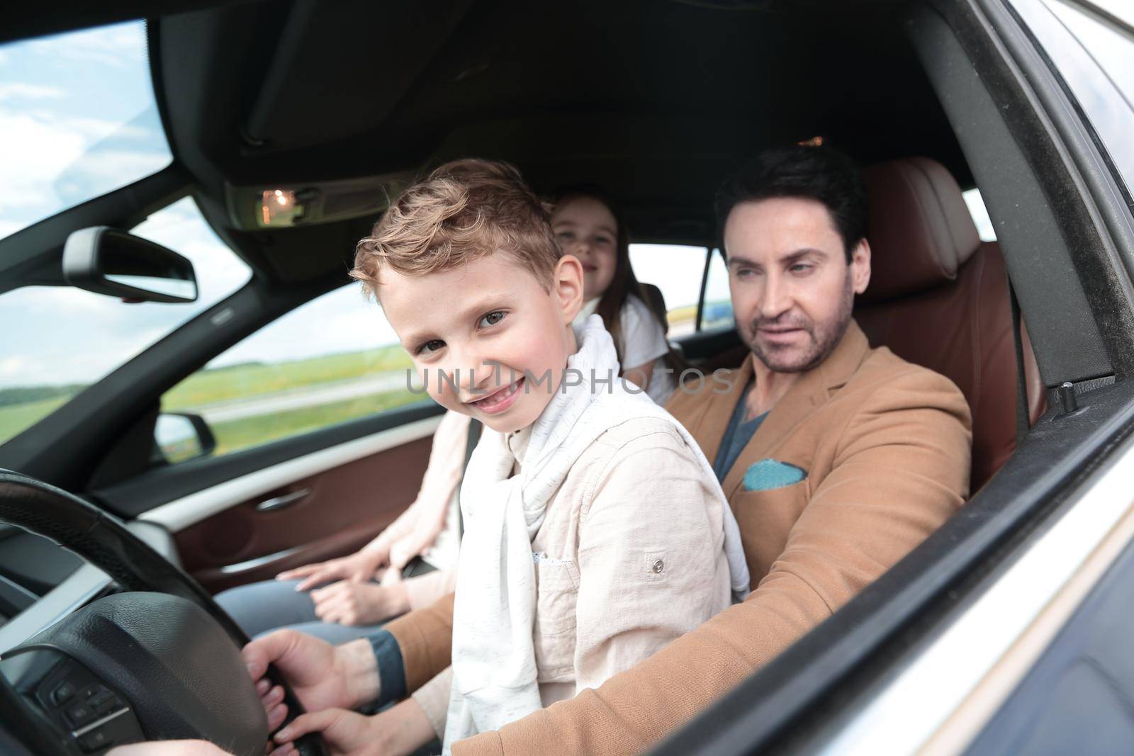 father and son driving a car by asdf