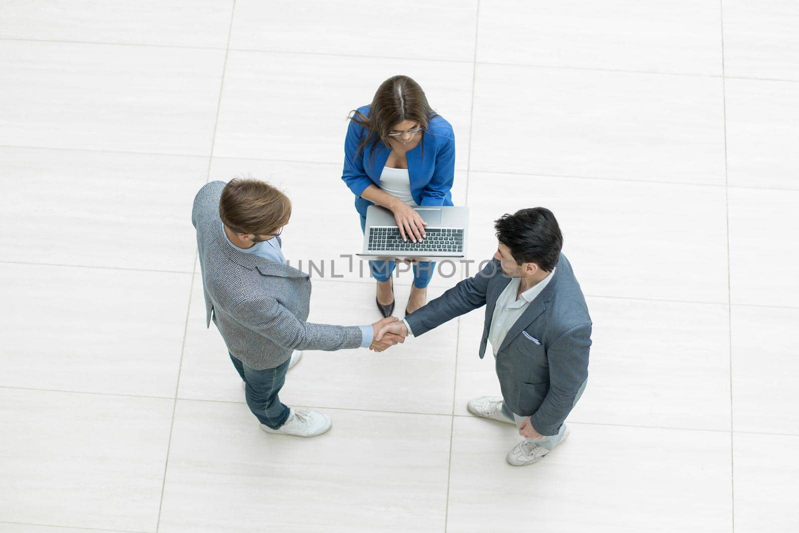 top view.business people shaking hands.isolated on white background