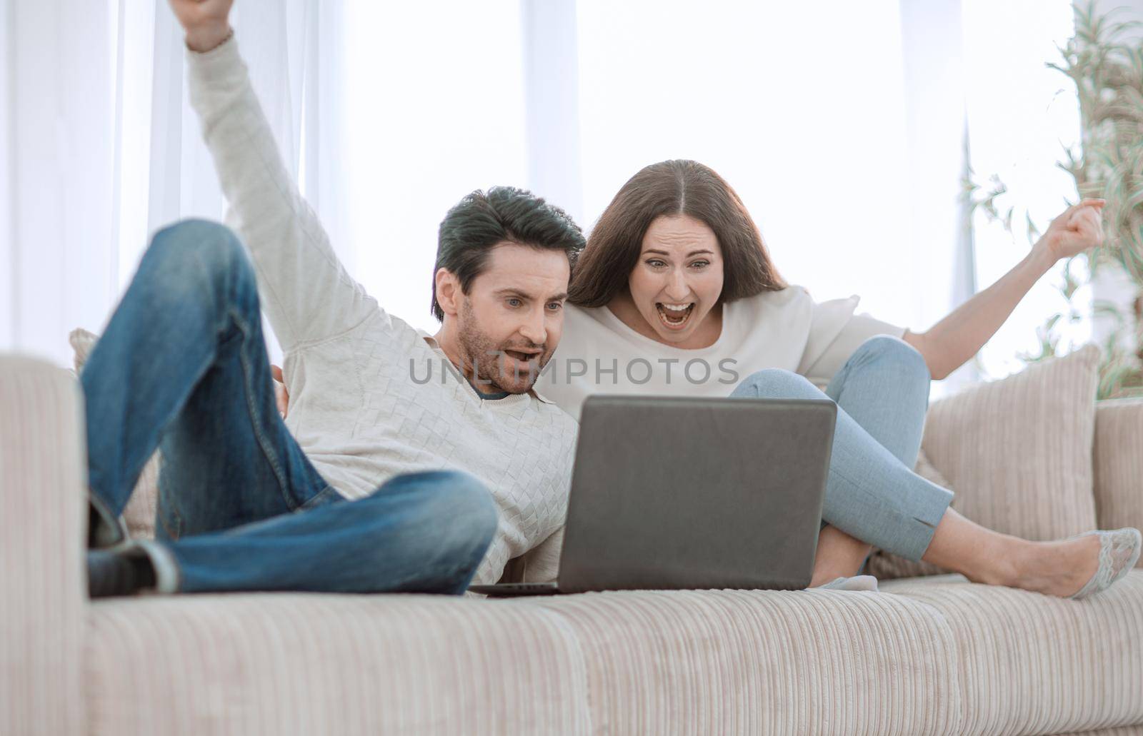 young couple watching TV shows on their laptop.people and technology