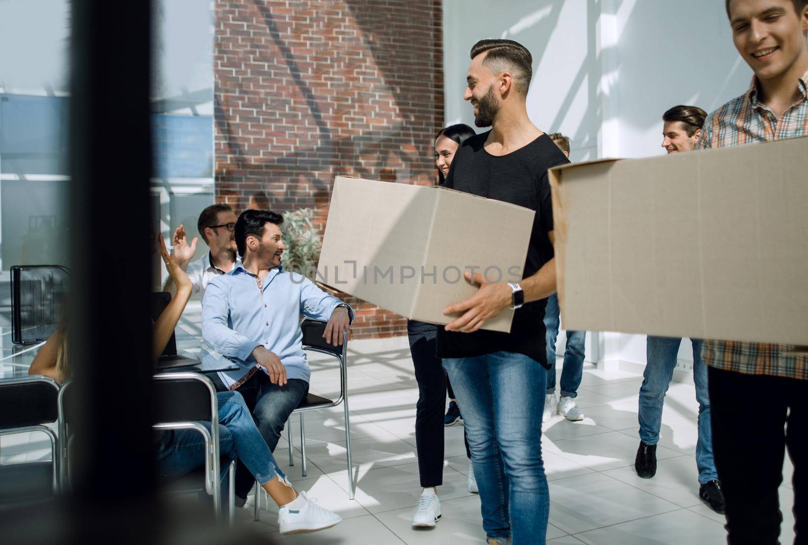 creative business team brings cardboard boxes to the new office.the concept of a startup