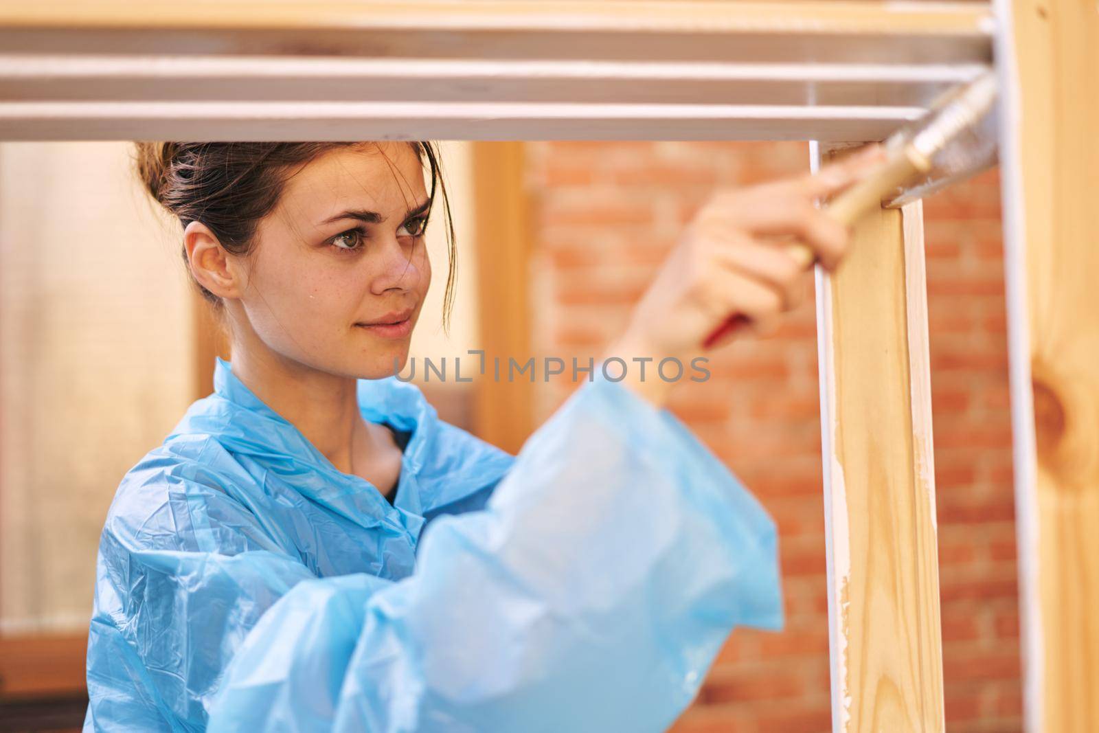 women paint wooden structures brush painter decoration. High quality photo