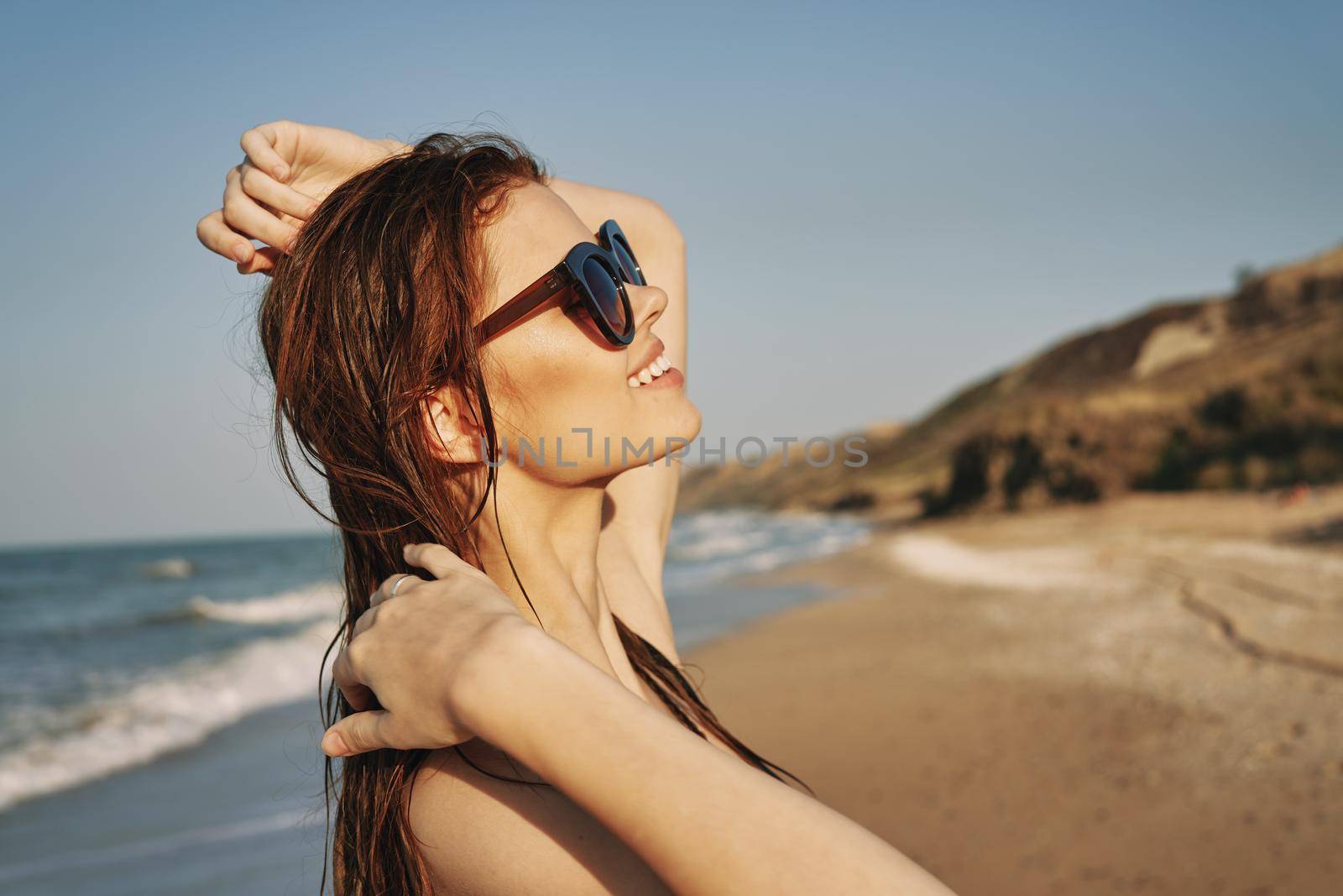 pretty woman in black swimsuit posing tanning tropics. High quality photo