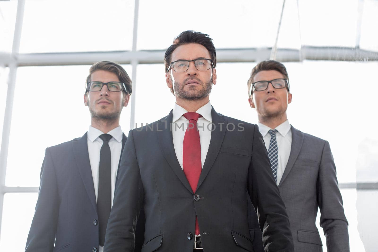 close up.three confident businessman standing in the office. the concept of cooperation