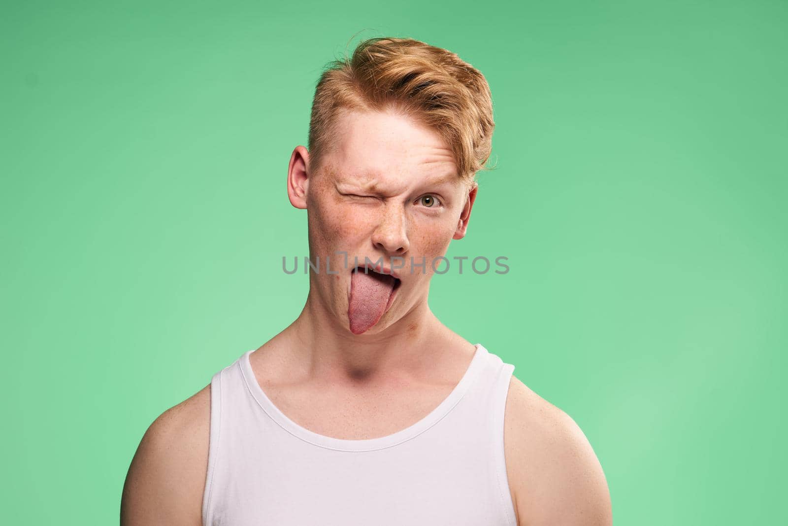 Redhead guy posing freckles close-up studio lifestyle. High quality photo