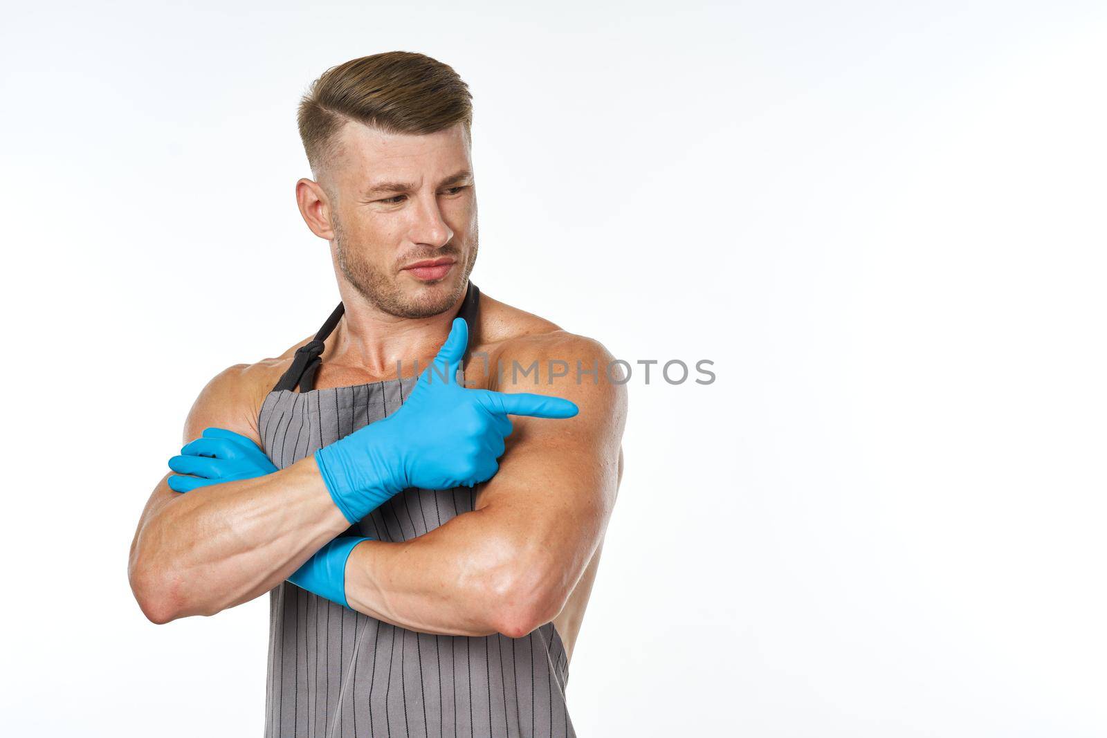 sporting man in aprons rubber homework gloves homework. High quality photo