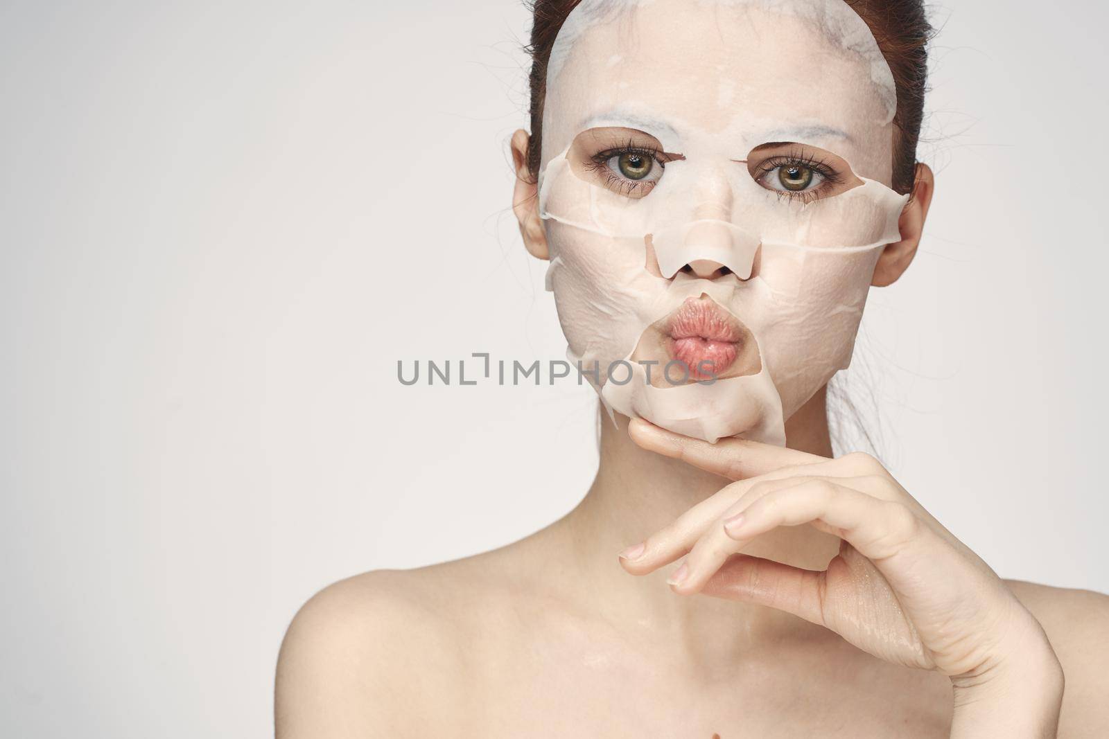 woman in cosmetic mask facial skin care rejuvenation by Vichizh