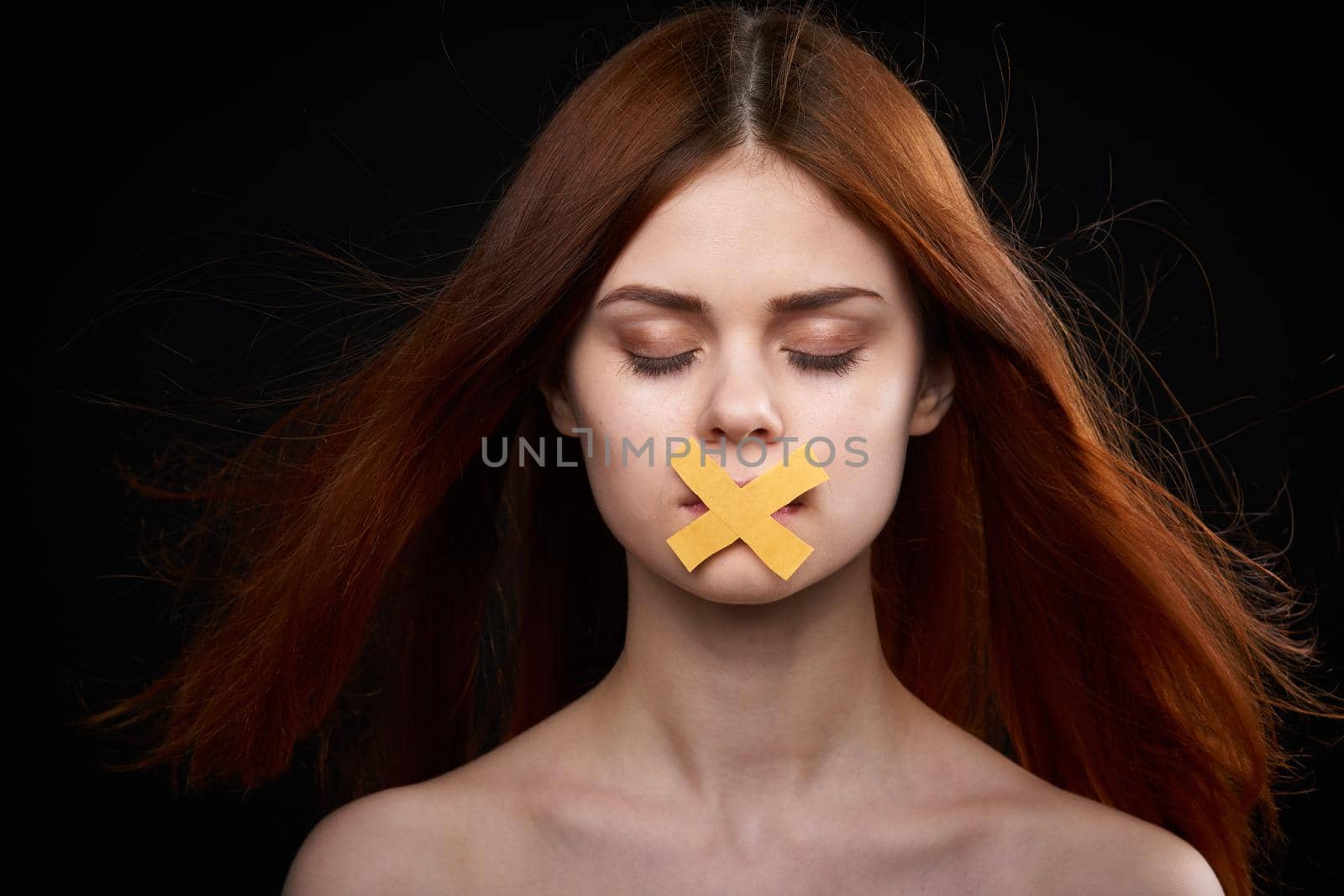 woman with bare shoulders taped mouth banned from diet. High quality photo