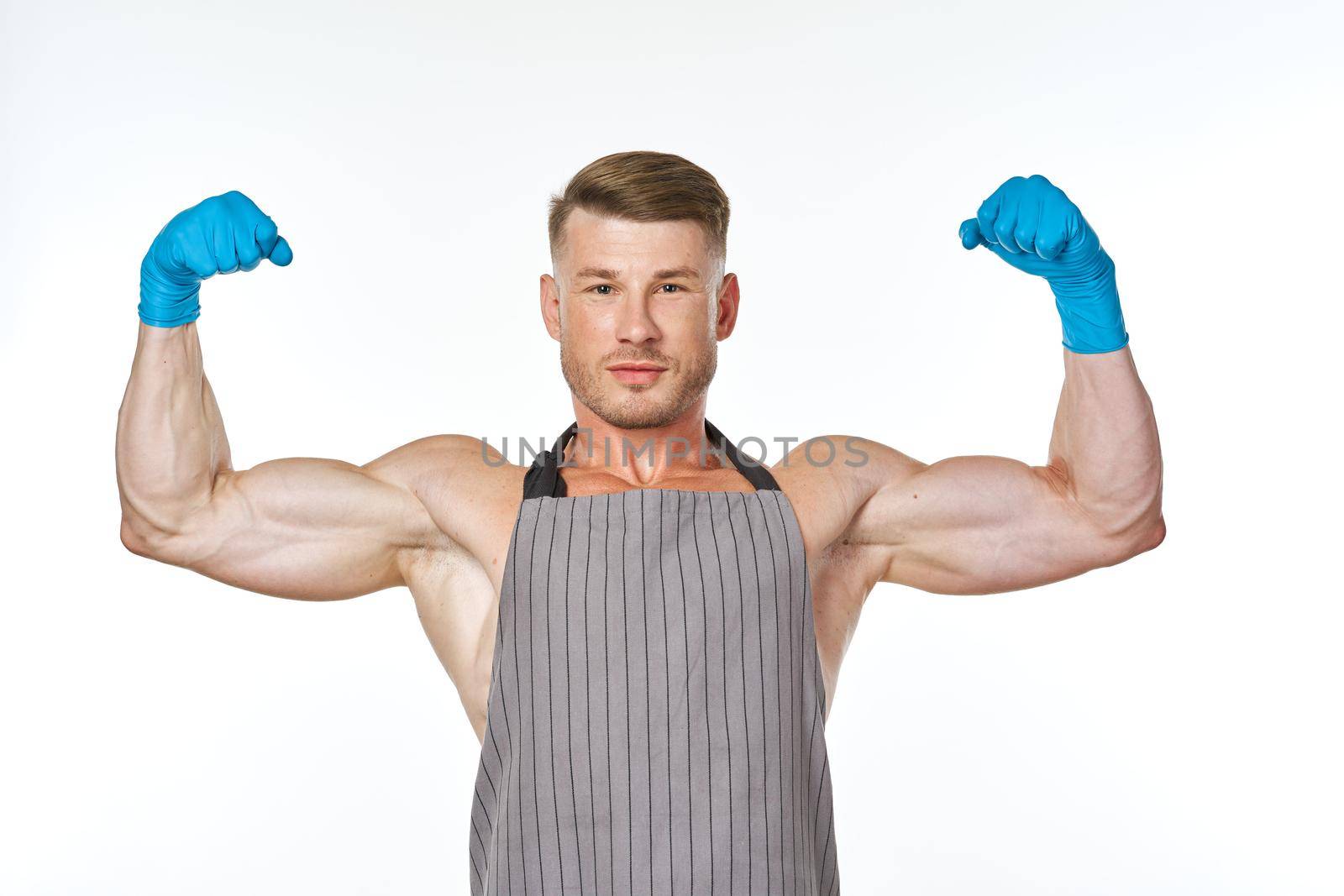 sporting man in aprons rubber homework gloves homework. High quality photo