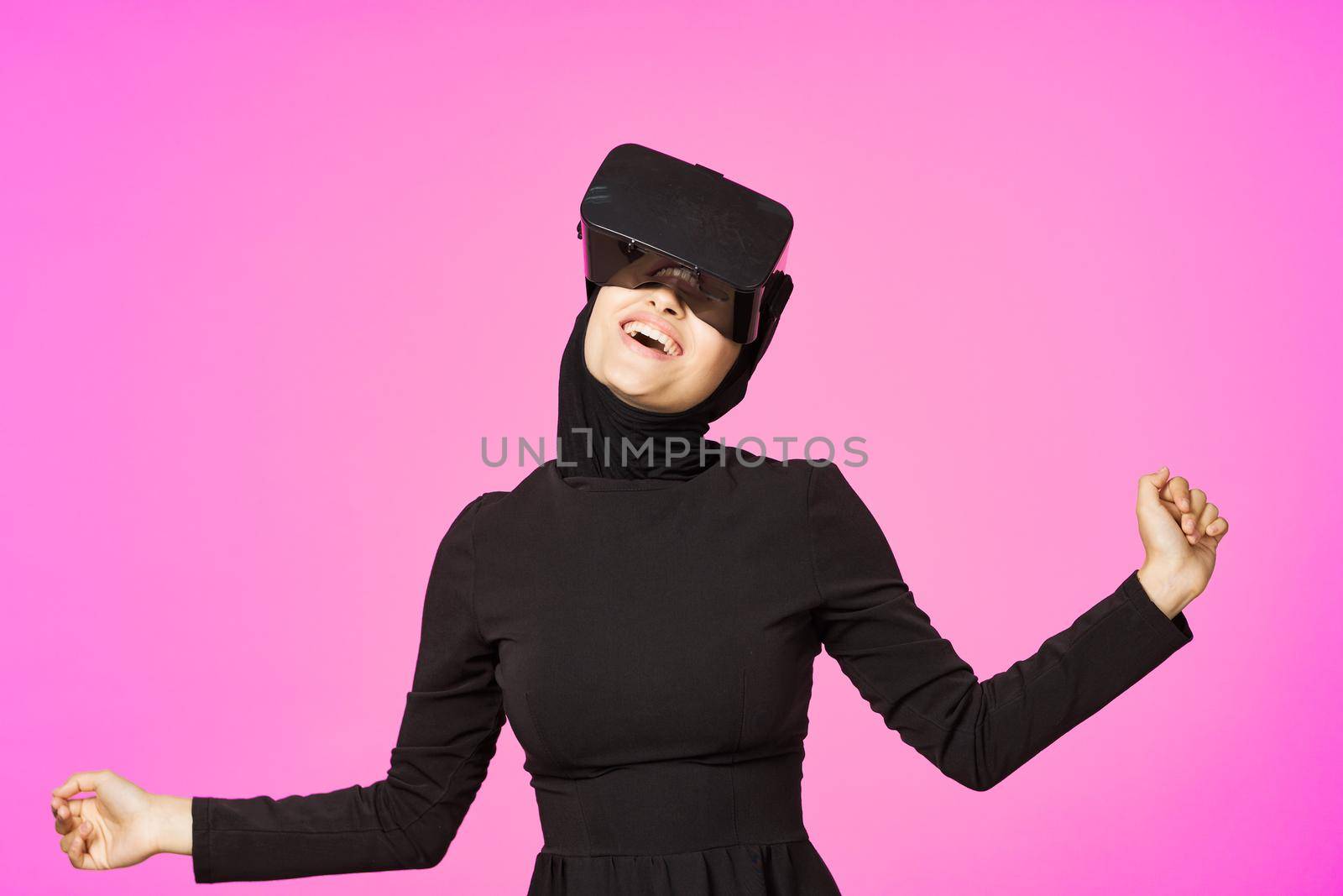 woman in black hijab glasses virtual reality technology movie watching by Vichizh