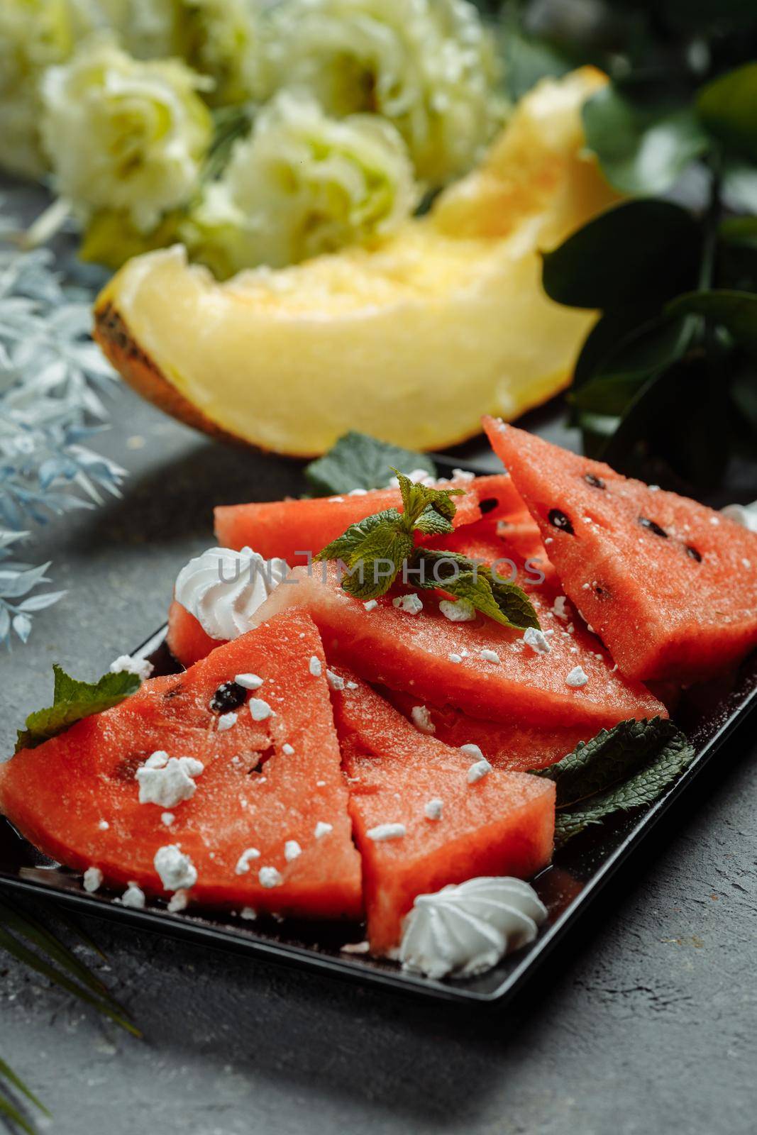 Pieces of fresh red watermelon on a black plate by UcheaD