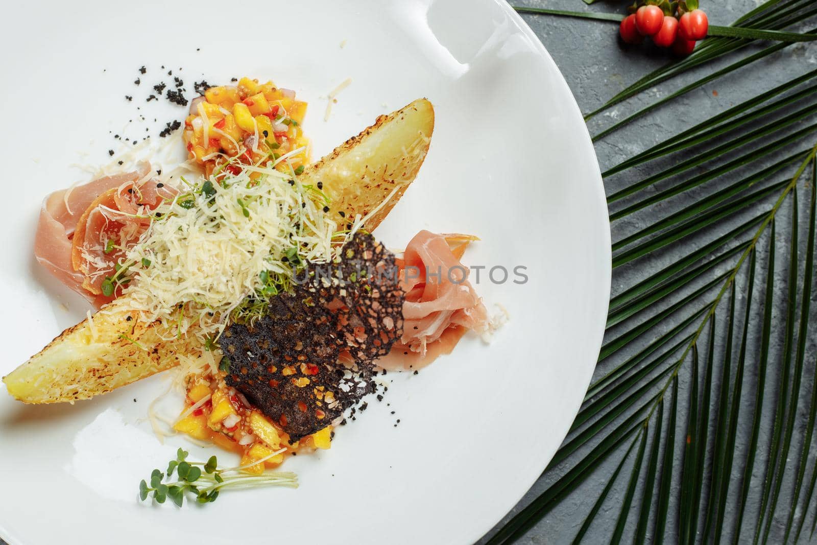 baked melon with parmesan and jamon on a white plate by UcheaD