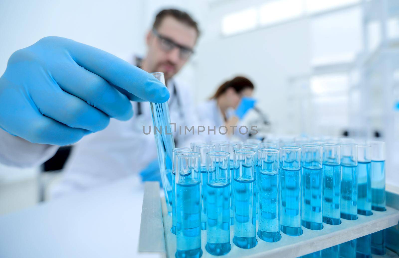 serious scientist working with liquids in the laboratory