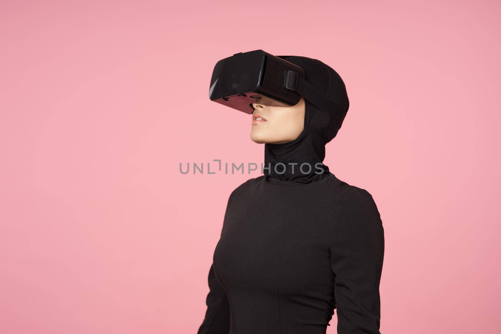 woman in black hijab glasses virtual reality technology movie watching. High quality photo