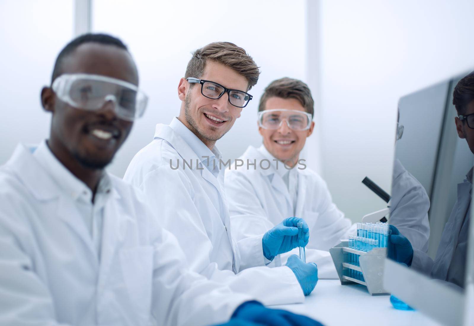 successful group of scientists sitting at their Desk.science and technology