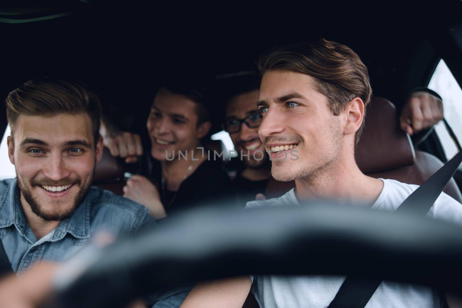 A group of people inside a car, on a road trip by asdf