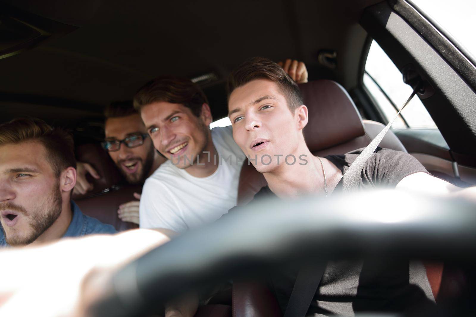 Group of happy friends on a car by asdf