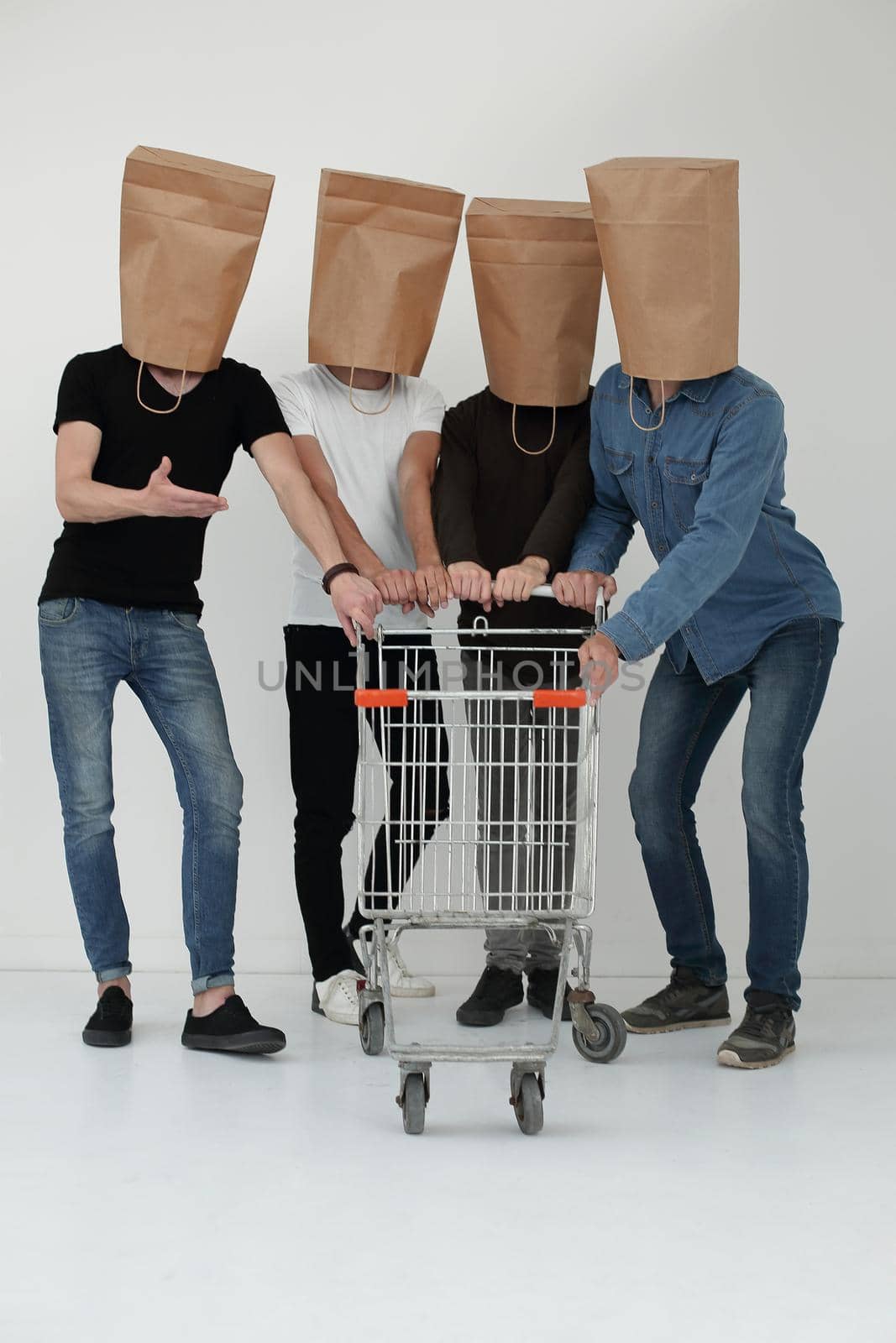 men with paper bags on head and shopping cart in hands on isolated background