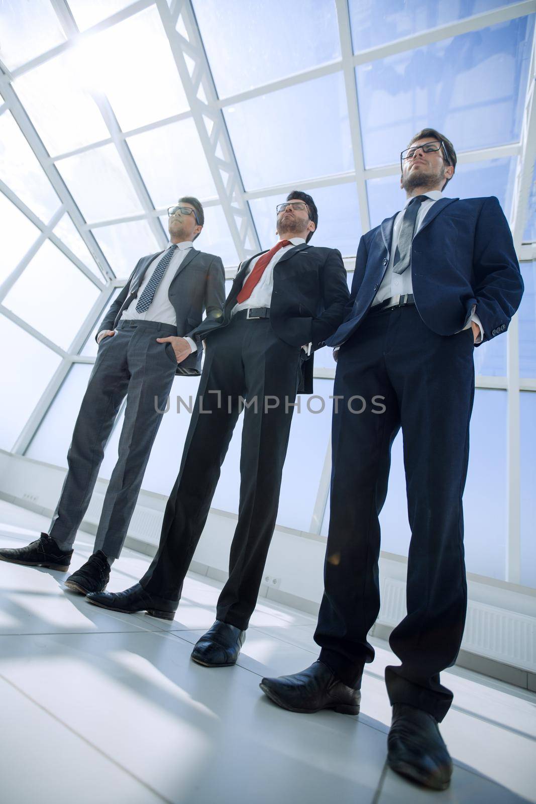 three business partners standing next to each other by asdf