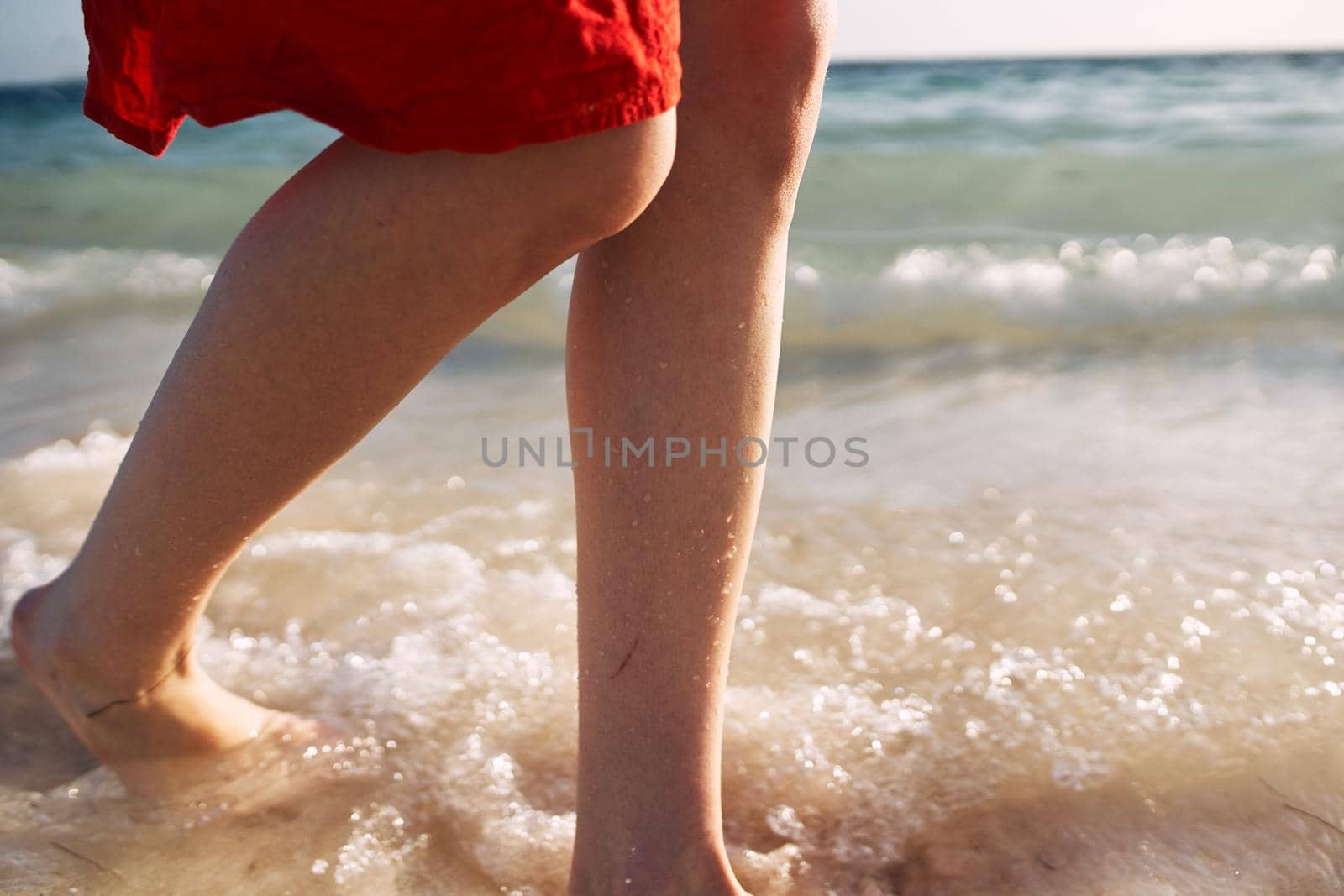 female feet ocean shore sand summer travel. High quality photo